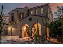 Charming two-story home with stucco finish, tile roof, arched entryway, and well-maintained desert landscaping at 13446 S 186Th Ave, Goodyear, AZ 85338
