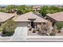 Charming single-story home featuring desert landscaping, covered entry, and a two-car garage at 15704 W Taylor St, Goodyear, AZ 85338