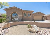 Charming single-story home with desert landscaping, stone accents, and an attached two-car garage at 1805 W Dusty Wren Dr, Phoenix, AZ 85085
