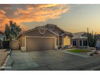 Inviting front exterior view of the home with a two car garage and lovely desert landscaping at sunset at 18845 N 23Rd Pl, Phoenix, AZ 85024