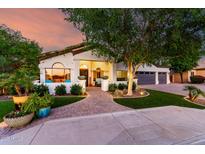 Charming facade with lush landscaping, brick walkway, and inviting front patio seating area at 2139 S Granite St, Gilbert, AZ 85295