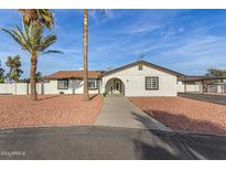Charming single-story home with white stucco and red rock landscaping in a sunny neighborhood at 22312 W Hammond Dr, Buckeye, AZ 85326