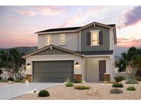 Two-story home showcasing a gray color scheme, complemented by desert landscaping at 2569 E Music Mountain Ave, Apache Junction, AZ 85119