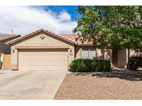 Charming single-story home with a two-car garage and low-maintenance landscaping, situated under a vibrant blue sky at 30587 N Maple Chase Dr, San Tan Valley, AZ 85143
