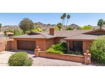 Charming single-story brick home with a well-kept front yard and attached two-car garage at 3131 E Las Rocas Dr, Phoenix, AZ 85028
