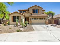 Inviting two-story home with desert landscaping, a two-car garage, and a basketball hoop on a sunny day at 32901 N Hidden Canyon Dr, San Tan Valley, AZ 85144