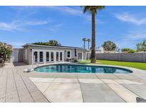 A refreshing private pool with a basketball hoop, a patio area, and lush palm trees at 4216 N 20Th St, Phoenix, AZ 85016