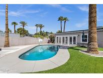 A stunning private pool with basketball hoop, patio and palm trees, perfect for entertaining at 4216 N 20Th St, Phoenix, AZ 85016
