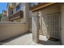 Exterior shot featuring a covered entryway with security screen door and a private patio area at 839 S Westwood -- # 170, Mesa, AZ 85210