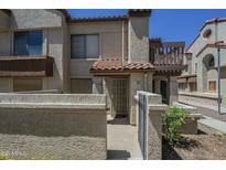 Inviting condo exterior with a private courtyard and gate, offering a cozy and secure entrance at 839 S Westwood -- # 170, Mesa, AZ 85210