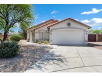 Charming single-story home with a well-manicured front yard and a two-car garage at 1120 S Valley Dr, Apache Junction, AZ 85120