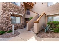 Inviting condo exterior with stone accents and meticulously maintained desert landscaping at 16801 N 94Th St # 2056, Scottsdale, AZ 85260