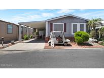 Charming house with a golf cart, a covered driveway, and landscaping at 17200 W Bell Rd # 1748, Surprise, AZ 85374