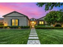 Charming single-story home with a beautifully landscaped front yard and inviting entrance pathway at 17690 E Bronco Dr, Queen Creek, AZ 85142