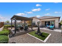 Beautiful backyard with a pergola-covered seating area, a water feature, and outdoor dining set at 18225 N 66Th Way, Phoenix, AZ 85054