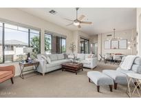 Expansive living room featuring a plush sectional sofa, leather ottoman, and sun-filled windows at 2989 N 44Th St # 3044, Phoenix, AZ 85018