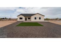 Charming single-story home featuring desert landscaping, gray gravel, and a cozy front lawn square at 3880 S 331St Ave, Tonopah, AZ 85354