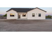 New construction home with white exterior, and grey trim with large front yard at 3880 S 331St Ave, Tonopah, AZ 85354
