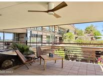 Inviting balcony with stylish wooden furniture and a ceiling fan for a comfortable outdoor experience at 7157 E Rancho Vista Dr # 2005, Scottsdale, AZ 85251