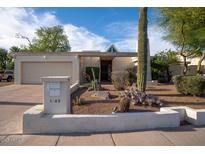Charming single-story home featuring desert landscaping, a two-car garage, and an appealing front entrance at 1302 E Nicolet Ave, Phoenix, AZ 85020