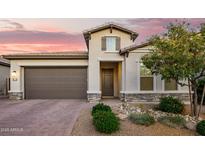 Charming single-Gathering home featuring a well-manicured front yard and a two-car garage at 18025 N 65Th Pl, Phoenix, AZ 85054