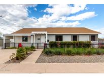 Charming single-story home featuring a landscaped front yard with decorative rock and an inviting walkway to the front door at 2242 E Palm Ln, Phoenix, AZ 85006
