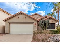 Charming single-story home featuring a well-manicured yard, two-car garage, and a classic Southwestern-style design at 3505 E South Fork Dr, Phoenix, AZ 85044