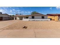 Charming single-story home with a low brick wall and a spacious driveway, perfect for comfortable living at 3826 W Davidson Ln, Phoenix, AZ 85051
