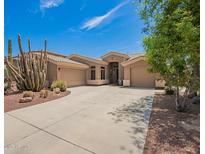 Charming single-story home featuring desert landscaping, a spacious driveway, and a welcoming facade with a large 3-car garage at 4667 E County Down Dr, Chandler, AZ 85249