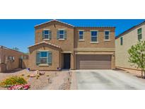 Charming two-story home featuring a desert landscape, tile roof, and attached two-car garage at 7112 N 126Th Ln, Glendale, AZ 85307