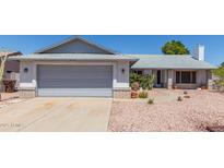 Charming single-story home with a spacious two-car garage and desert landscaping at 8020 W Windrose Dr, Peoria, AZ 85381