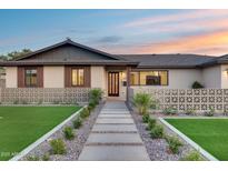 Inviting front entrance with a decorative fence, leading to a modern style front door at 8117 E Lewis Ave, Scottsdale, AZ 85257