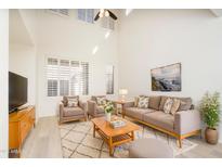 Bright living room featuring high ceilings, large windows, and modern neutral decor at 1024 E Frye Rd # 1090, Phoenix, AZ 85048