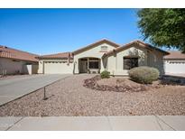 Charming single-story home featuring a well-manicured desert landscape and a cozy front porch seating area at 11840 N 59Th Ln, Glendale, AZ 85304