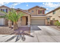 Inviting two-story home showcasing a well-manicured front yard and a convenient two-car garage at 121 W Hackberry Dr, Chandler, AZ 85248