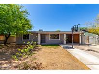 Charming single-story home with a well-kept yard and a convenient carport under a clear, blue sky at 1617 W Vineyard Rd, Phoenix, AZ 85041
