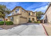 Front view of two-story home with landscaping, garage, and driveway on a sunny day at 17374 W Adams St, Goodyear, AZ 85338