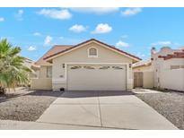 Charming single-story home showcasing a neutral color palette, tiled roof, and a spacious two-car garage at 2094 N Sweetwater Dr, Casa Grande, AZ 85122