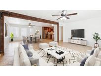 Bright and airy living room with a large rug, modern furniture, and an open floor plan at 3228 W Mercer Ln, Phoenix, AZ 85029