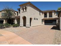 Charming two-story stucco home with a paved driveway and arched entryway provides curb appeal at 3330 W Gran Paradiso Dr, Phoenix, AZ 85086
