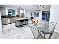 Bright open-concept living space seamlessly connects the kitchen, living room, and dining area at 3330 W Gran Paradiso Dr, Phoenix, AZ 85086