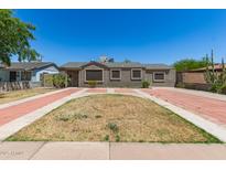 Charming single-story home with a well-manicured yard and a spacious driveway at 4303 N 18Th St, Phoenix, AZ 85016