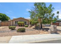 Charming single-story home with desert landscaping, mature tree, and great curb appeal at 5319 E Gelding Dr, Scottsdale, AZ 85254