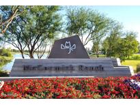 Community entrance sign for McCormick Ranch, with lush landscaping and a peaceful lake in the background at 8306 E Via De Dorado --, Scottsdale, AZ 85258