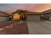Charming single-Gathering home with a terracotta roof, desert landscaping, and stone accents at 1011 E Amberwood Dr, Phoenix, AZ 85048