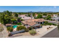 Desert home with a private pool, landscaped yard, tile roof and attached garage at 10205 E Corrine Dr, Scottsdale, AZ 85260