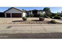 Charming single-Gathering home featuring a tile roof, desert landscaping, and a spacious driveway at 10205 E Corrine Dr, Scottsdale, AZ 85260