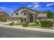 Charming two-story home with landscaped front yard and a three car garage, perfect for suburban living at 112 E Joseph Way, Gilbert, AZ 85295