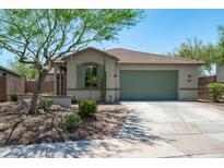 Charming single-story home featuring a low-maintenance yard, a two-car garage and attractive desert landscaping at 12727 W Lowden Rd, Peoria, AZ 85383