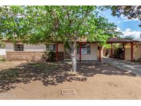 Charming single-story home with a covered carport, mature tree and mixed siding accents at 2308 W Marlette Ave, Phoenix, AZ 85015